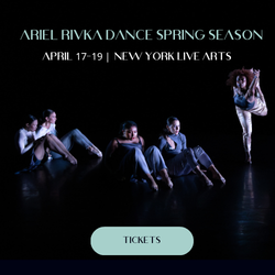 Company dancers sit and stand in various positions