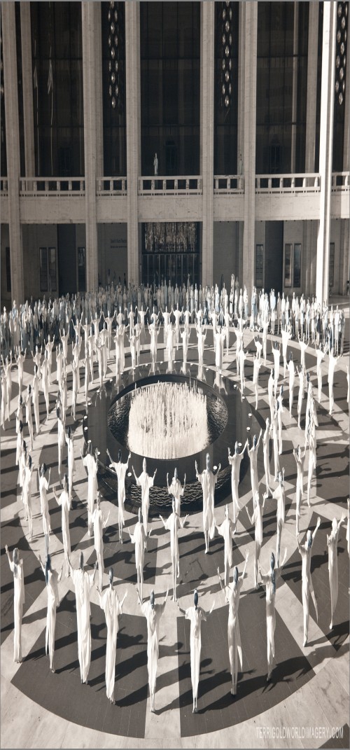 Dancers in white surround the Revson Fountain at Lincoln Center's plaza