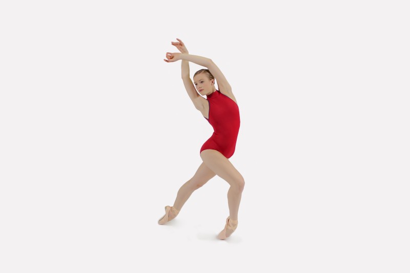 Dancer in a red leotard and pointe shoes