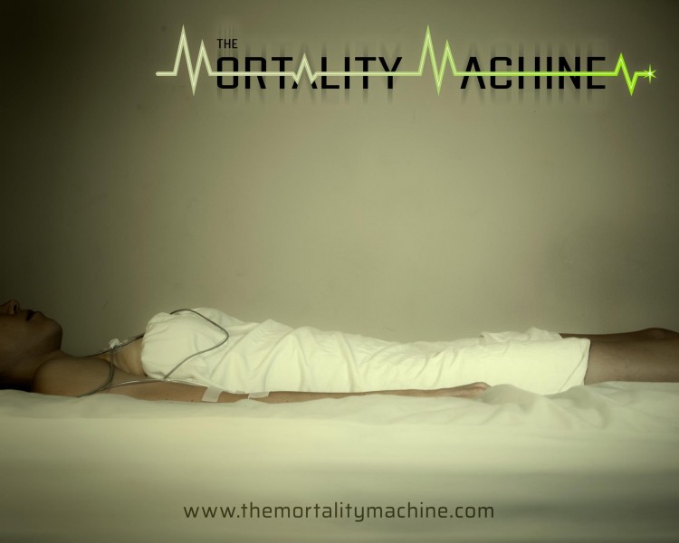 The Mortality Machine show poster. A female wrapped in a white sheet lies on a white bed hooked up to an IV and EKG.