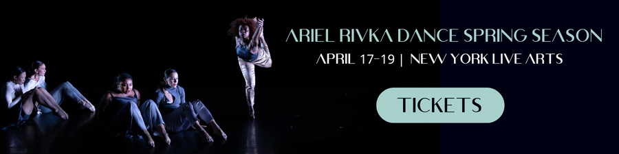 Company dancers sit and stand in various positions