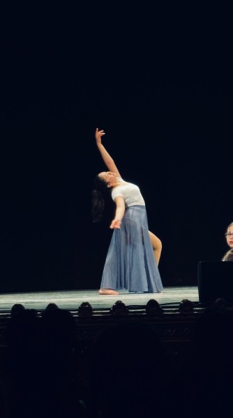 Solo student dancer on large stage