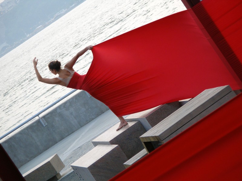 Dancer in long piece of red fabric