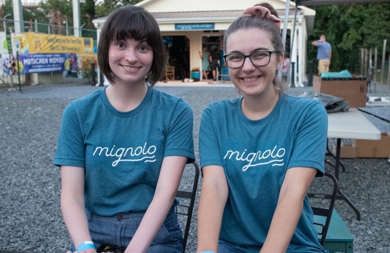 Mignolo interns seated at ticket booth at Mignolo Arts Grand Opening Gala, September 2021