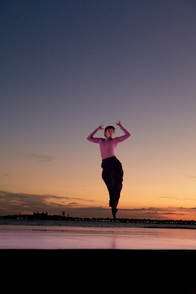 Dancer captured mid air hovering from Peridance at sunset