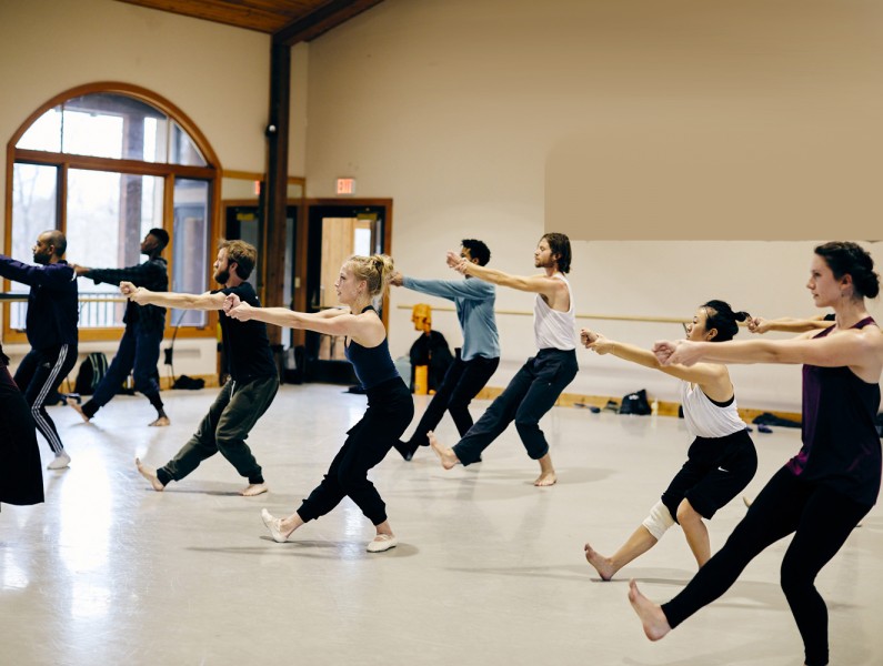 Group of dancers taking Limón technique class in a dance studio