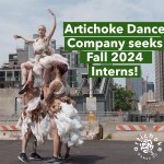 Four dancers wearing costumes made of recycled plastic bags perform a lift with one dancer in the air.