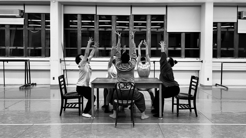five dancers dancing around a table