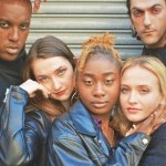 Karma Stylz, Kaitlin Hill, Annia Nelson, Jamie Solomon and Rinor Zymberi wearing black leather and looking straight ahead.