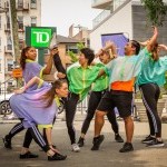 Dancers photographed mid-dance and outdoors in bright and fun colorful outfits at a Queensboro Dance Festival event