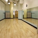 Photo of room, featuring sprung-wood floor and mirror wall