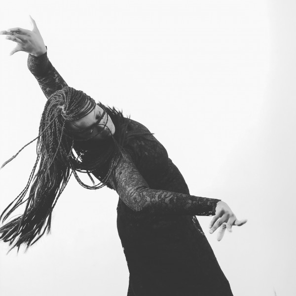 Black and white photo of Flamenco dancer in a back bend with her hair swirling around her face.
