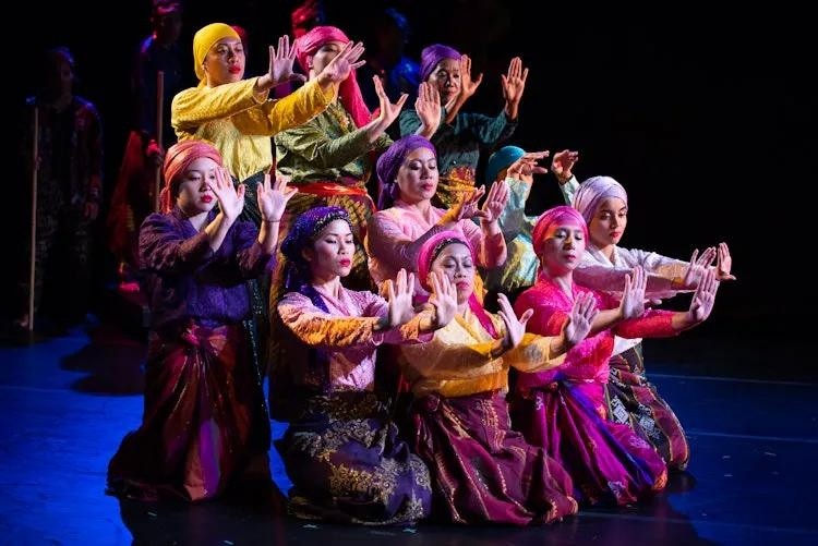 Group of performers wearing vibrant colors