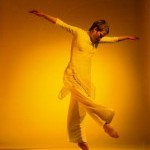 Woman dancing in yellow lighting 
