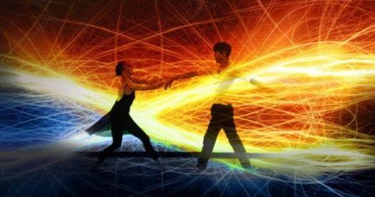There are two dancers against a background of vivid light.