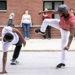 Two hip hop dancers perform on the street