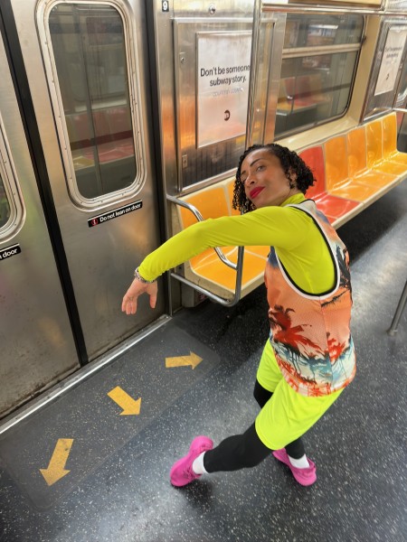 Dancer in orange and yellow, dancing in subway with similar colors