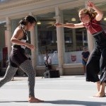 Two dancers perform outside.