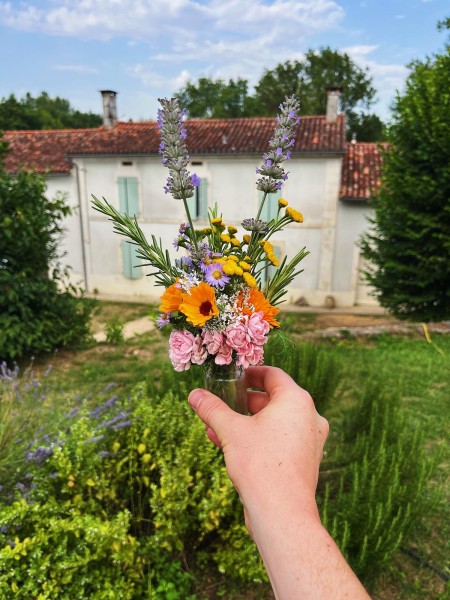 A small bouquet held in front of the main house at Moulin/Belle