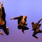 Three dancers from MMDC jumping in the air