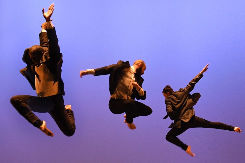 Three dancers from MMDC jumping in the air