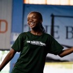 Young dancer smiles while performing dance.