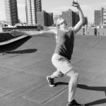 Man dancing on roof in bright sunlight.