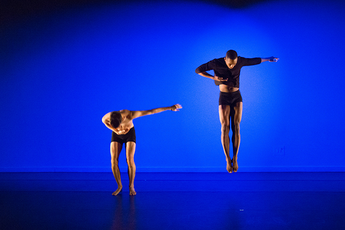 Two male dancers soaring in the air