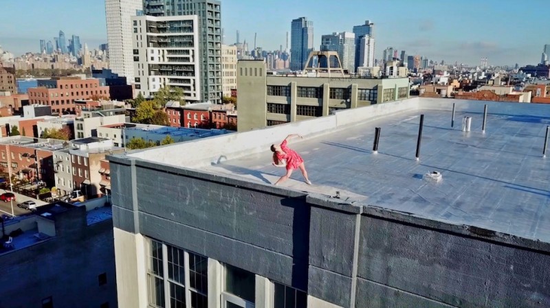 Dancer in red dress atop Brooklyn roof