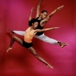 Two dancers captured in a jump