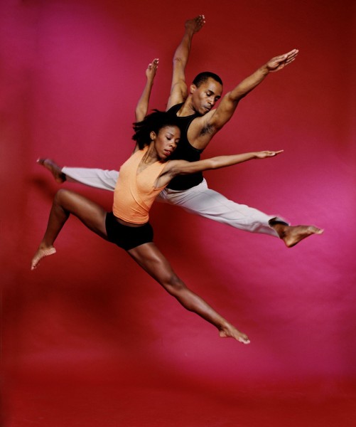 Two dancers captured in a jump