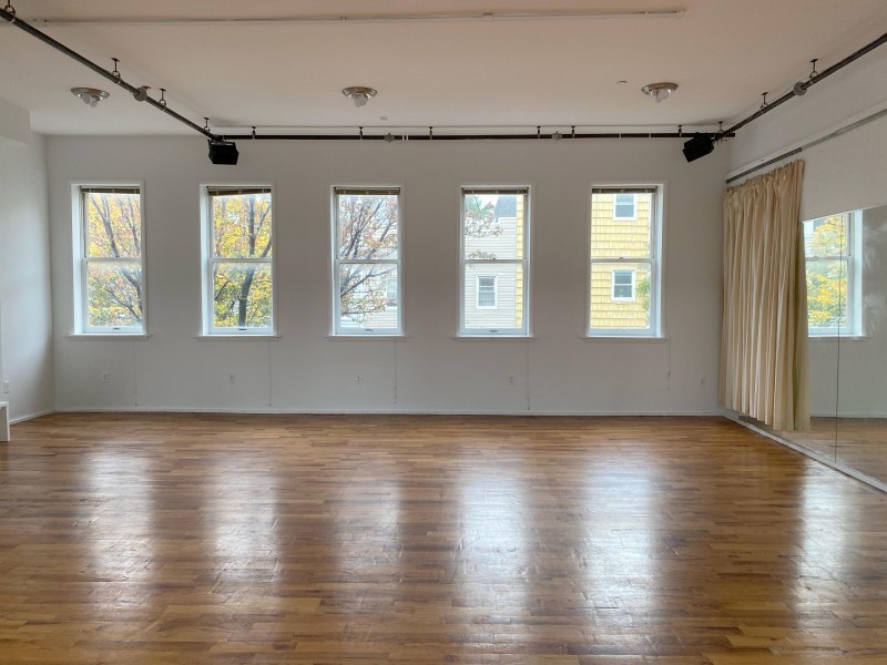 Photo of Douglas Elliman Rehearsal Studio with hardwood floors, white walls, full-length mirror, and lot’s of natural light.