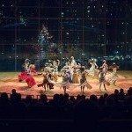 Dancers on stage in front of glass window