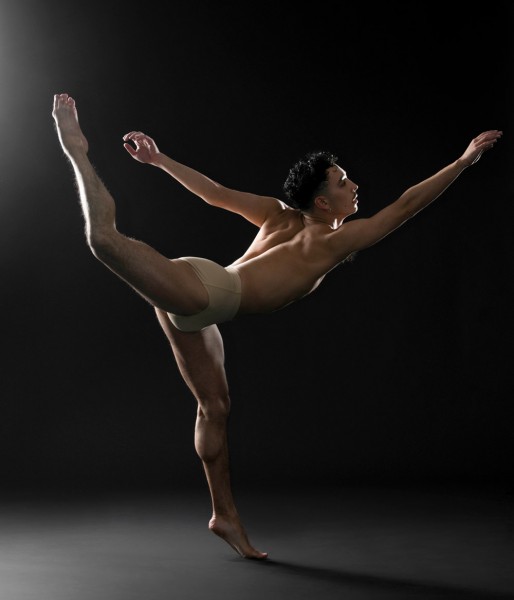 Photo of Artistic Associate Jacob Thoman. Jacob is in profile in a back attitude, with one arm reaching forward.