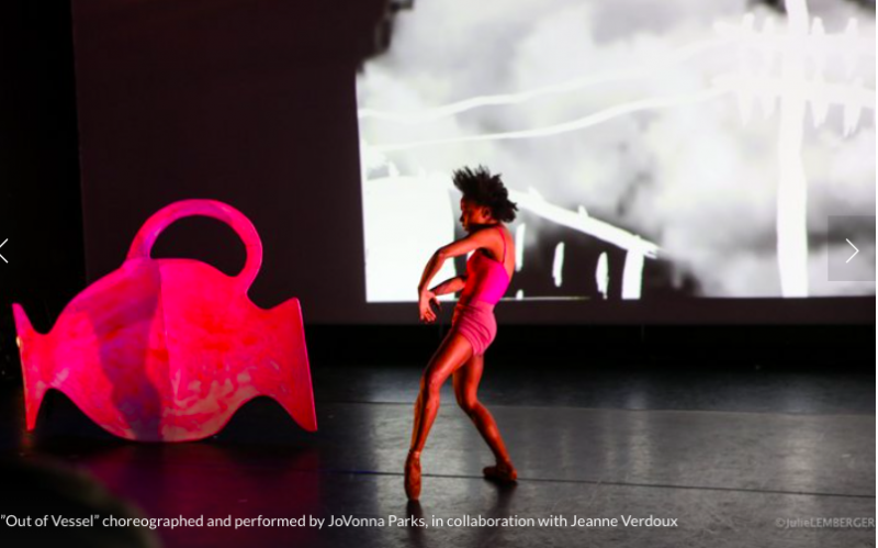 Dancer JoVonna Parks dances next to a tipped pink vessel