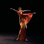 Male dancer lifting female dancer overhead