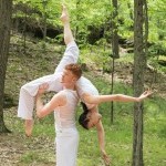 Hanna Q Dance Company, Male Dancers lifting female dancer over his shoulder. Dressed in white. 