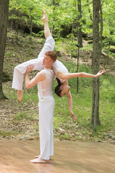 Hanna Q Dance Company, Male Dancers lifting female dancer over his shoulder. Dressed in white. 