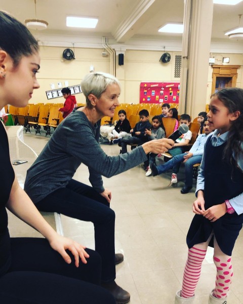 Marie-Christine Giordano and dancer speaking to a student of a public school