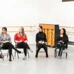 A group of teaching artists sitting in a circle listening to the instructor give direction. 