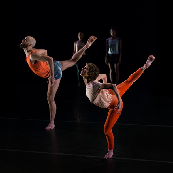 two dancers with their legs gesturing to the backspace while arching their torsos